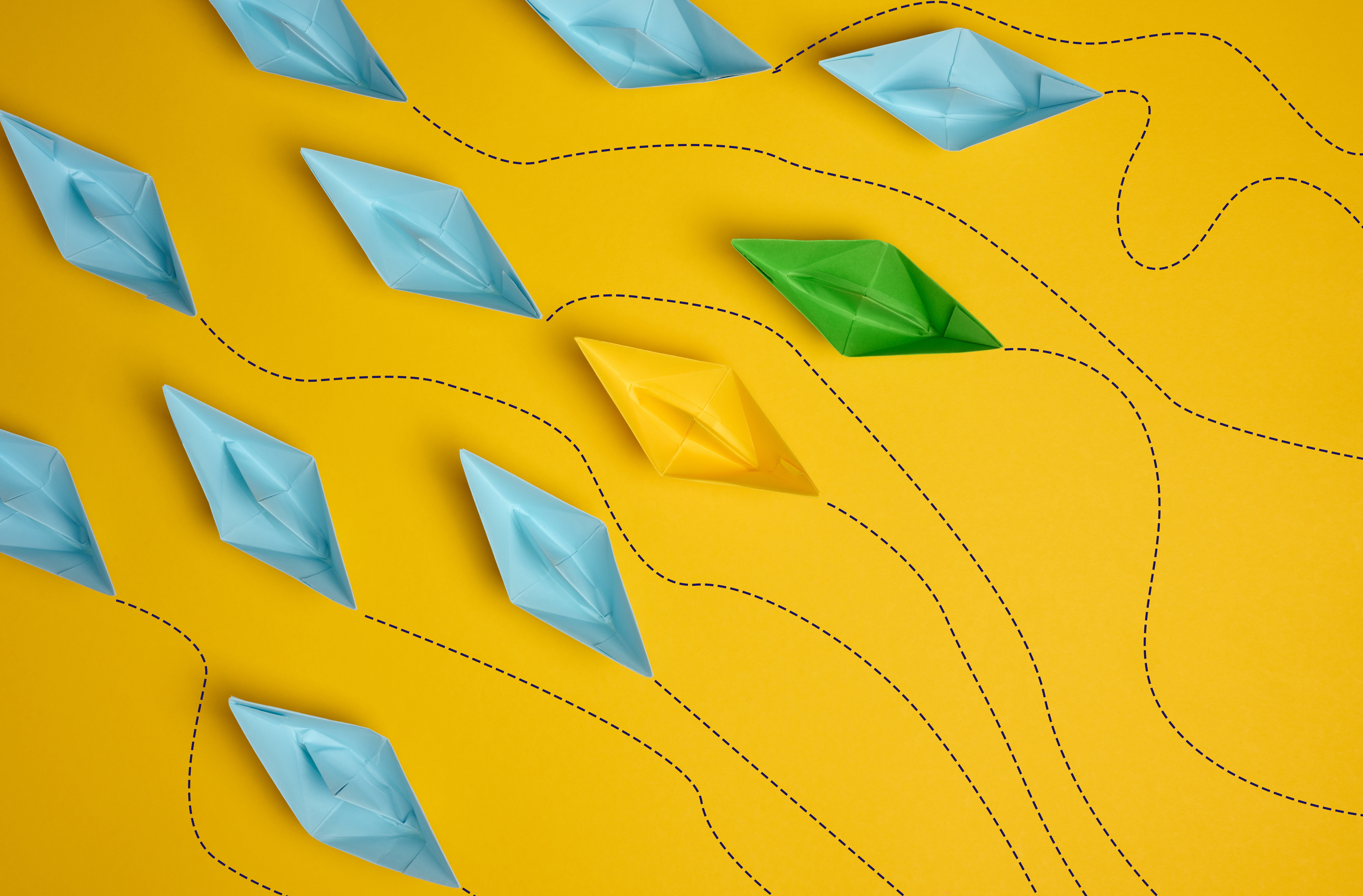 Paper,Boats,On,A,Yellow,Background,With,Paths,Of,Movement,